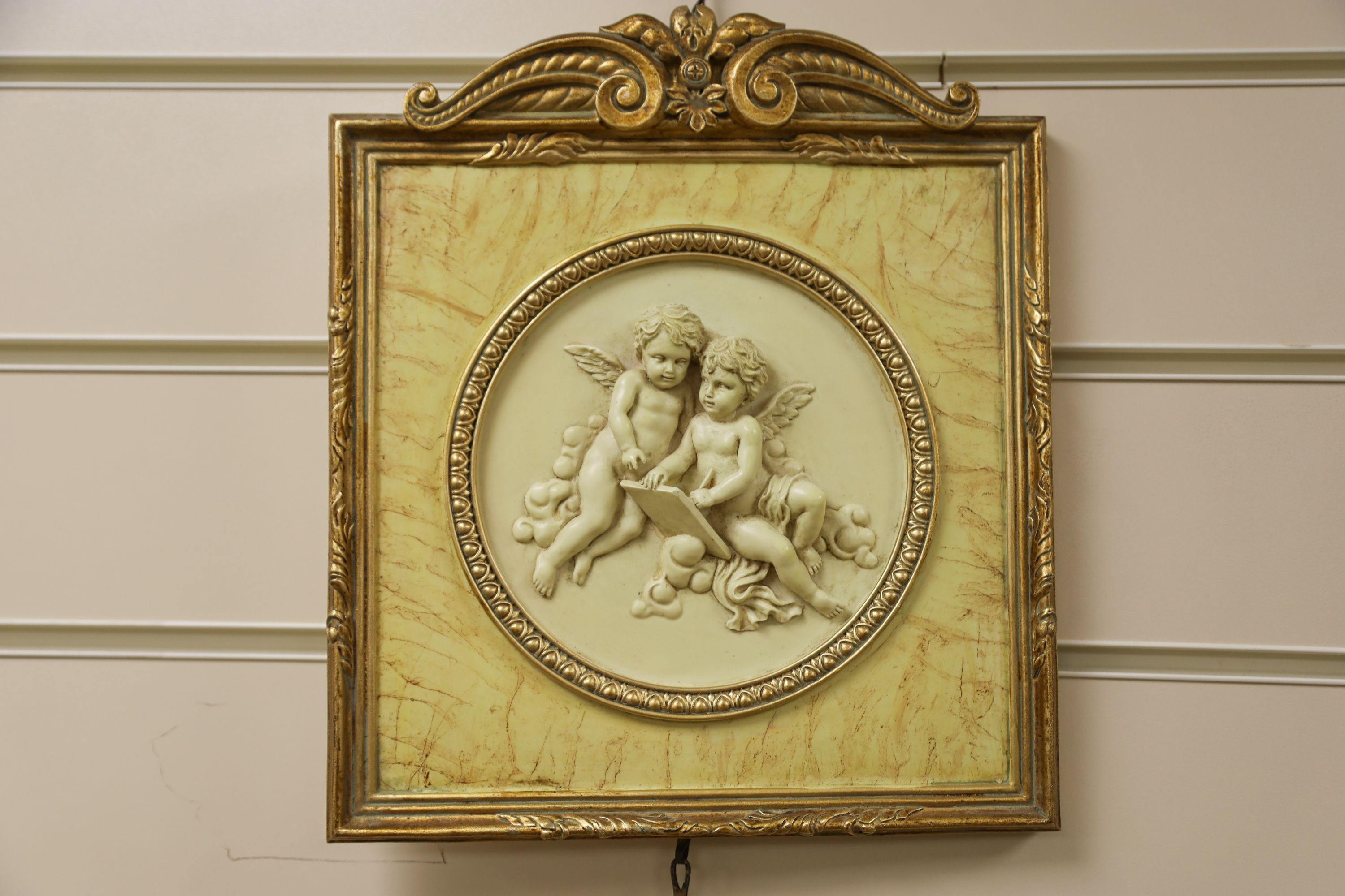 A set of three gilt framed composition plaques 27x23cm